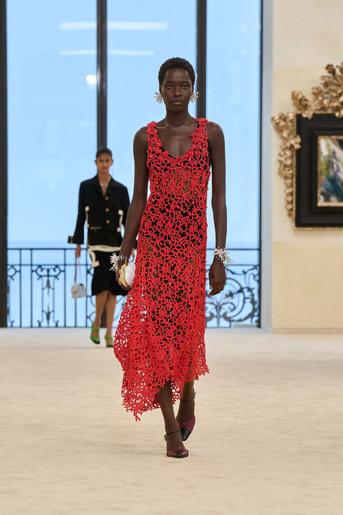 Chanel Resort 2027 runway look featuring the coral-red openwork embroidered dress.