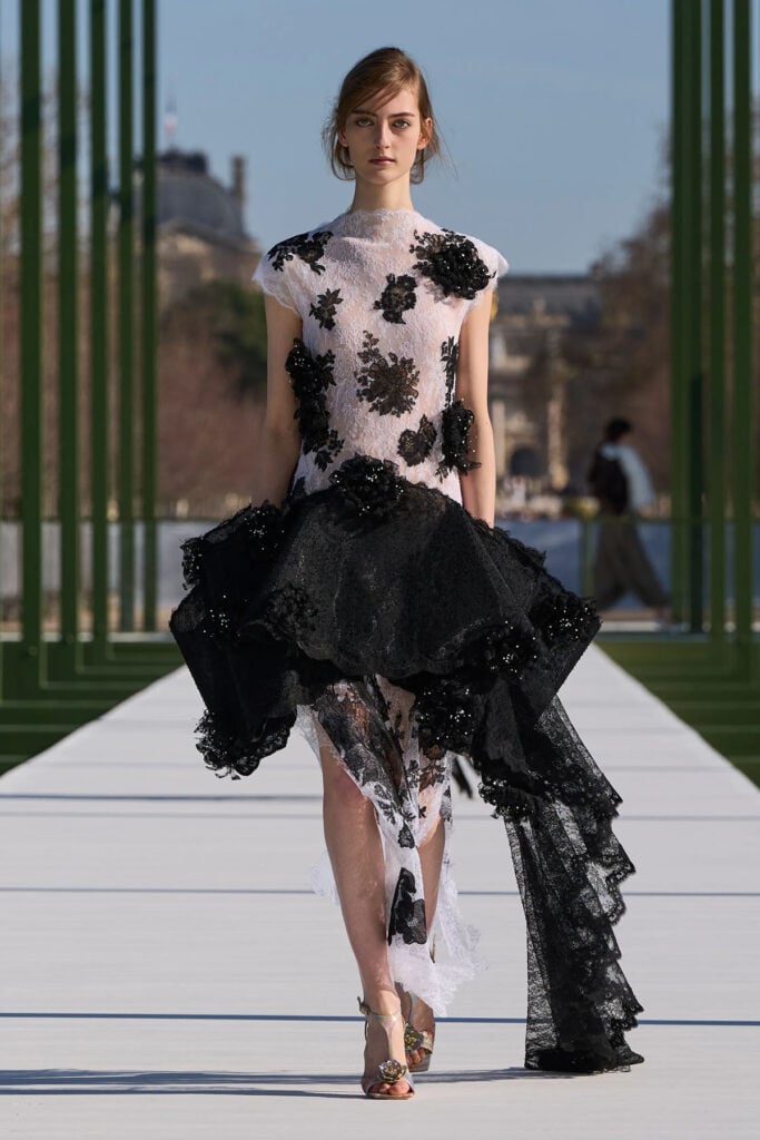 Dior Fall 2026 runway look featuring the original black-and-white lace gown before its red-carpet redesign.