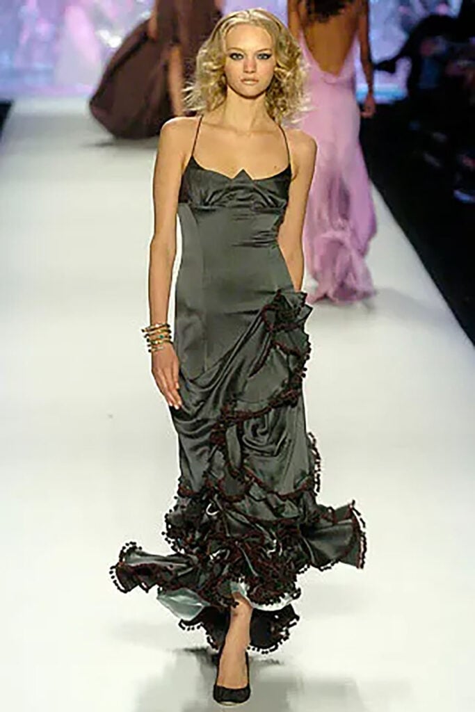 Zac Posen Fall 2005 plum satin dress with pom-pom flounce trim on the runway.